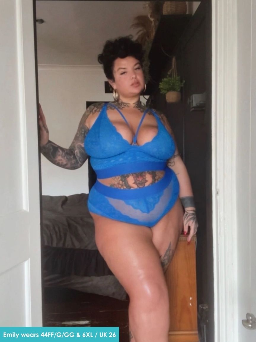Person wearing a blue lingerie set in a room.