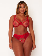 Woman wearing a red lingerie set on a white background