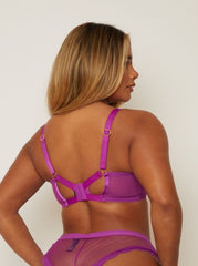 Person wearing a purple lingerie set against a plain background